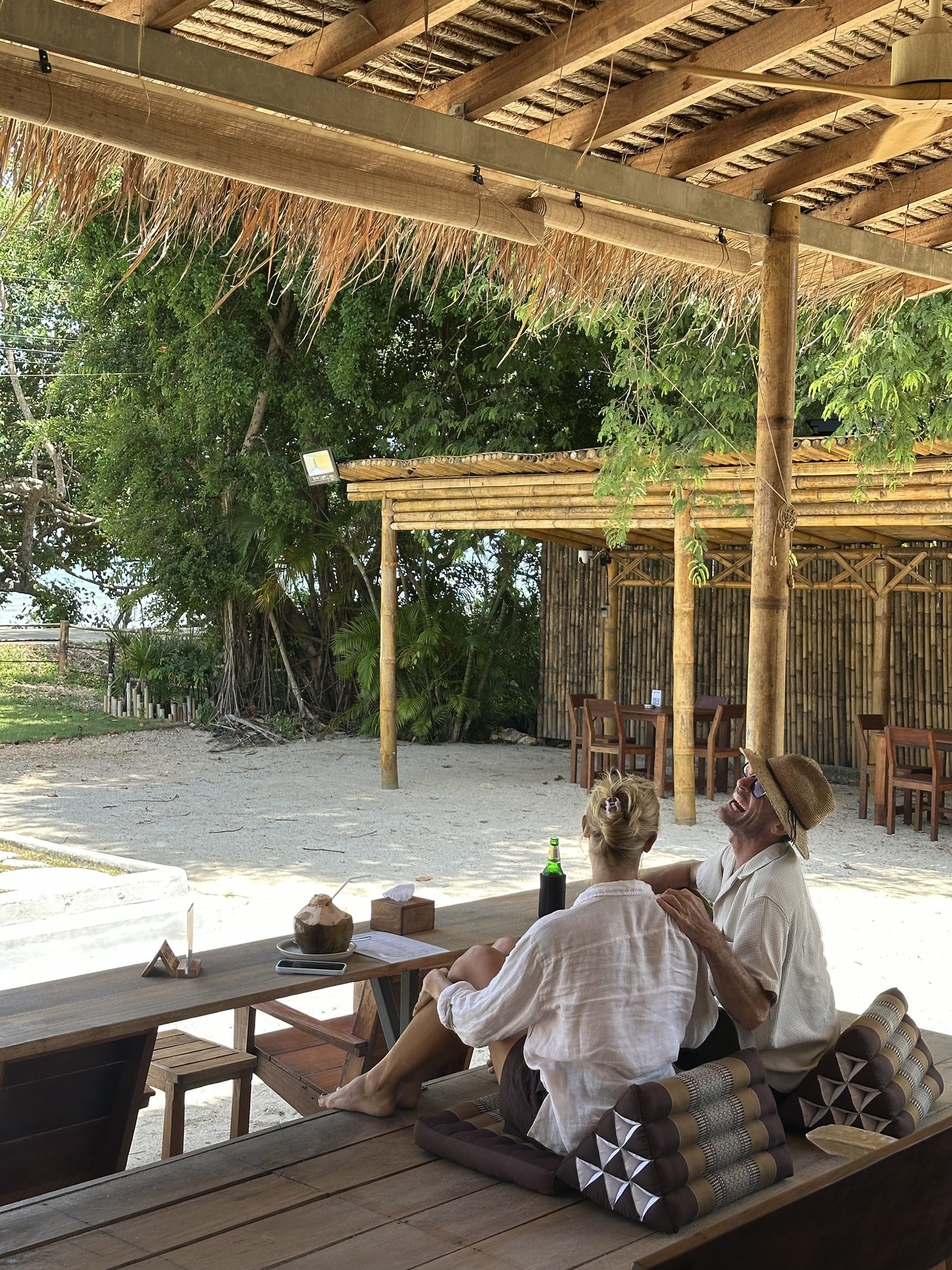 Guests relaxing under the bamboo pavilion at The Backyard